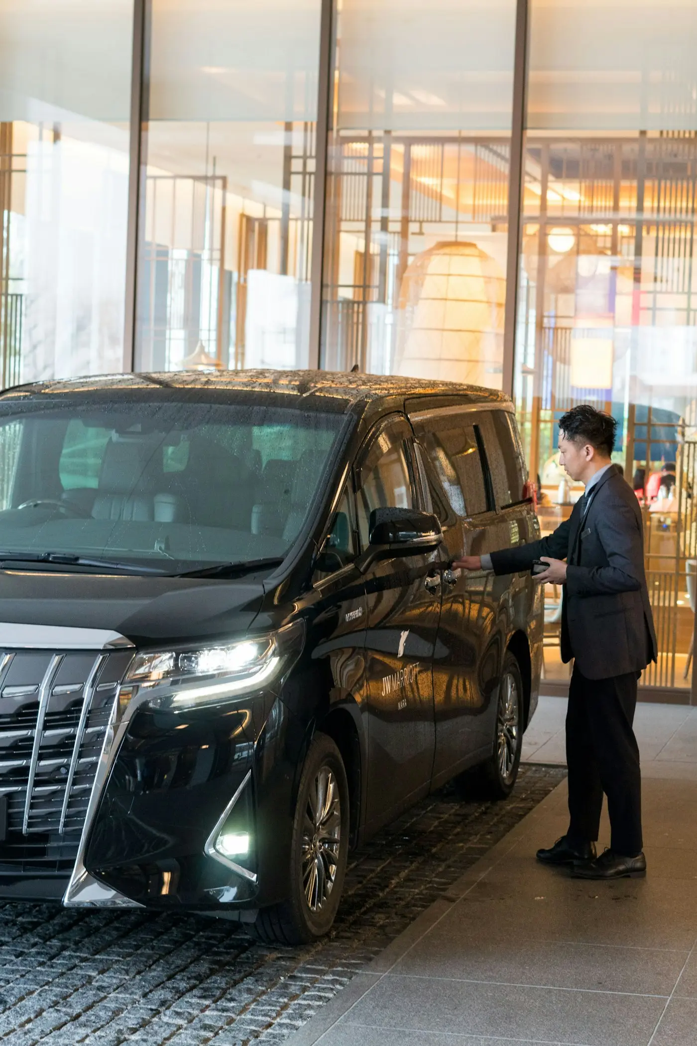 Driver opening the door of a private van